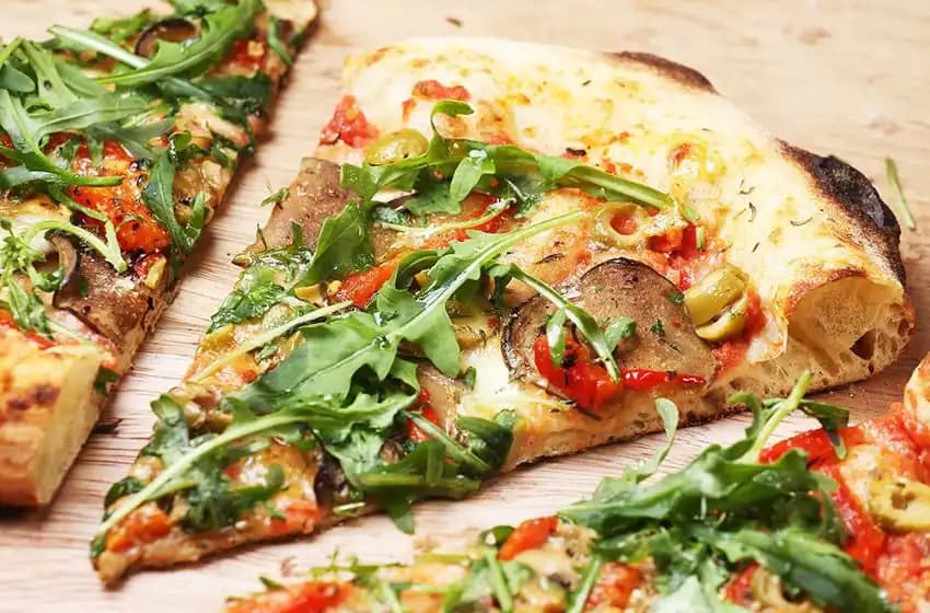 Italian style pizza slices with arugula